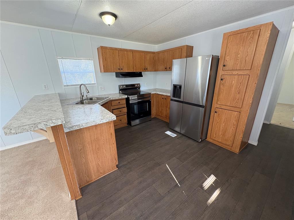 8939 Beverly Hills Road Lakeland, FL 33809 - Photo 23 of 23 a kitchen with stainless steel appliances granite countertop a refrigerator stove and a sink