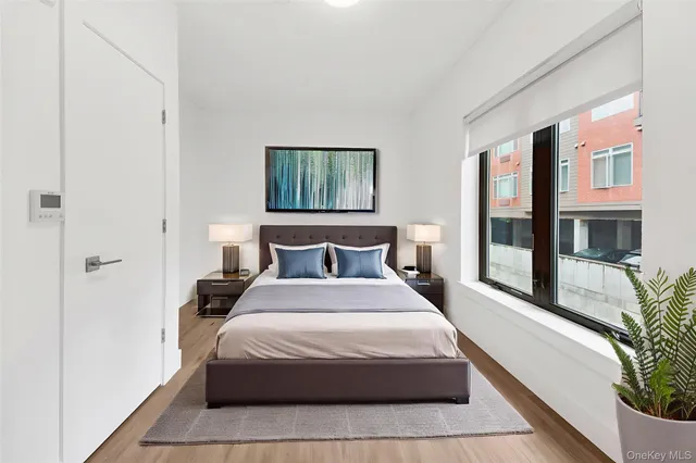 a bedroom with bed and large windows