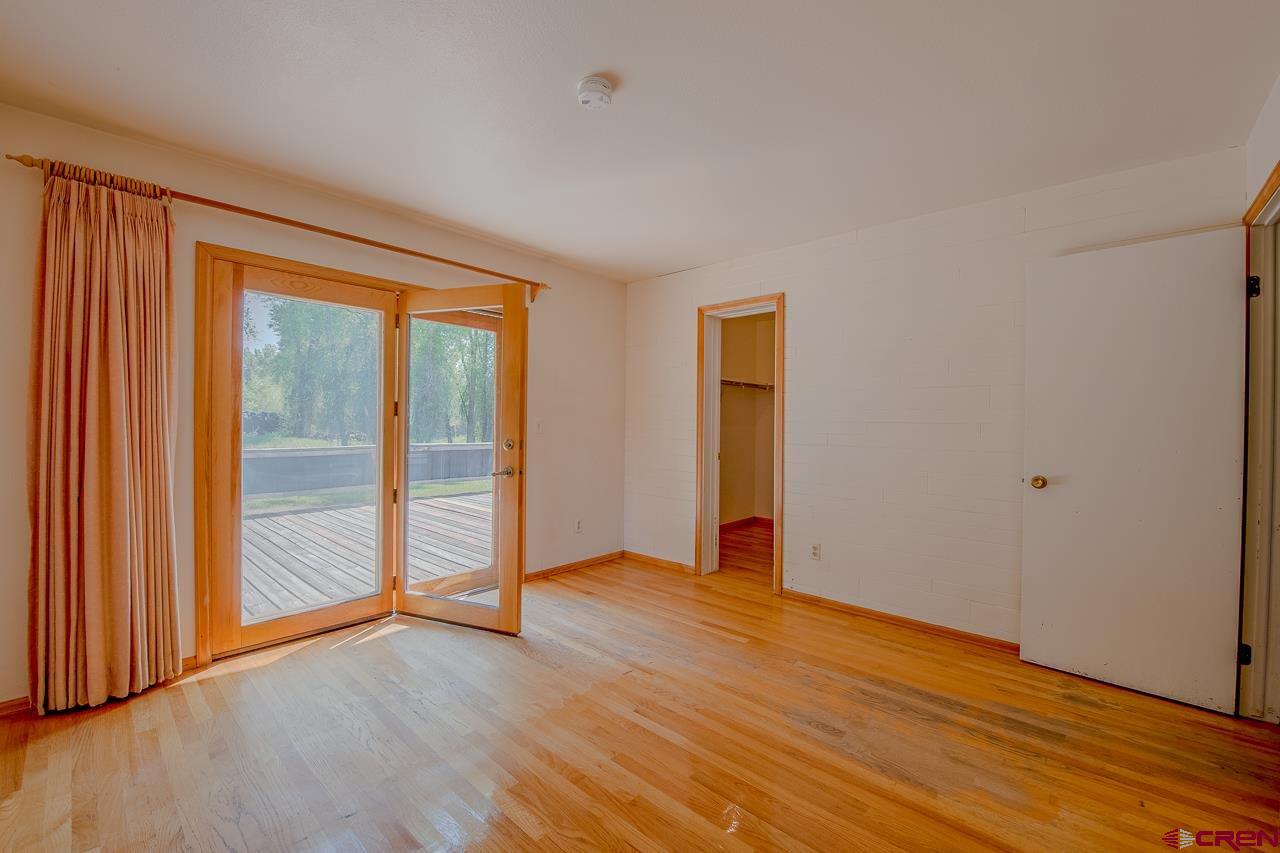 171 Arapahoe Road Gunnison, CO 81230 - Photo 18 of 34 Master suite, 3/4 bath, walk in closet, access to the back deck.