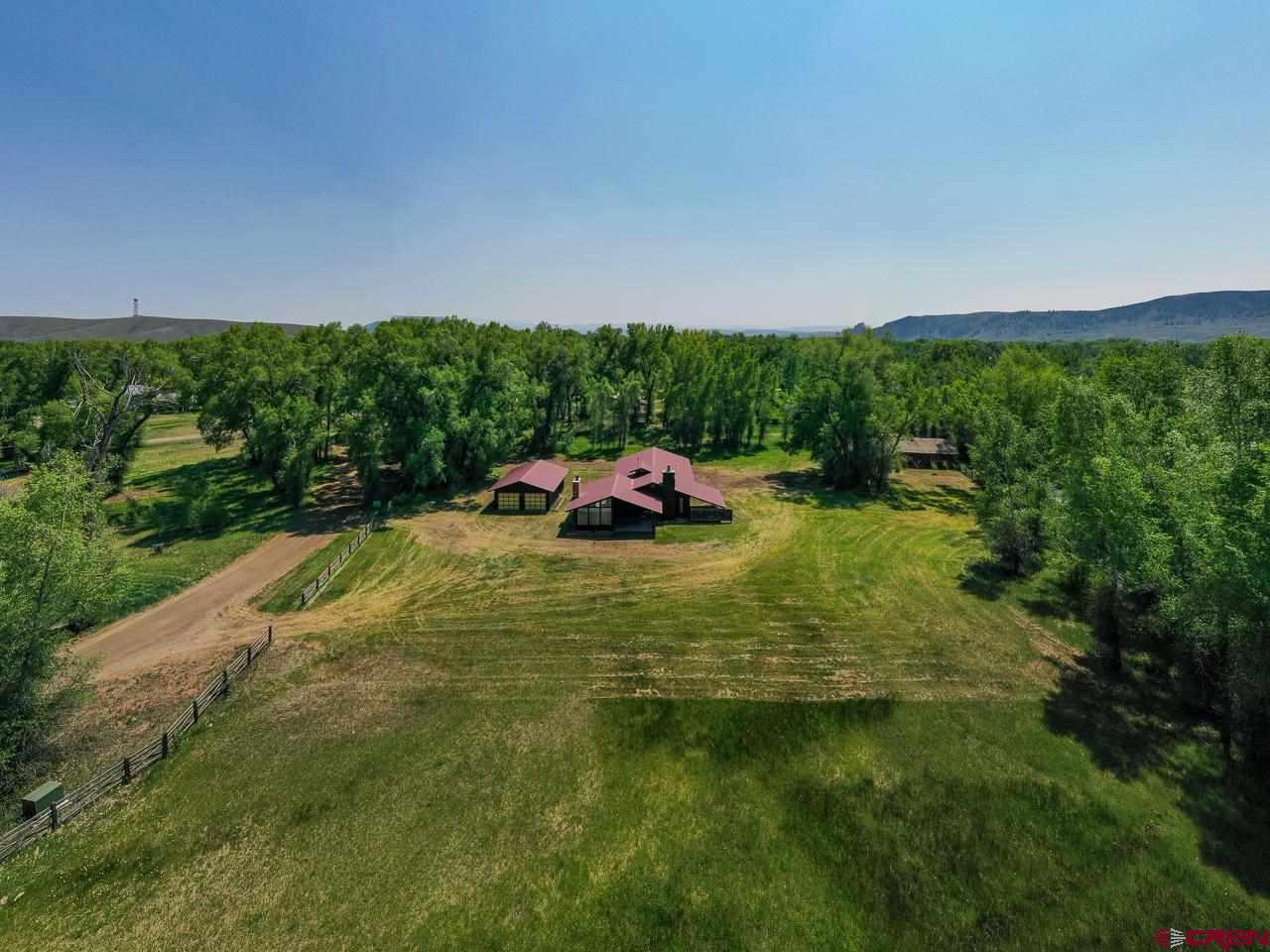 171 Arapahoe Road Gunnison, CO 81230 - Photo 2 of 34 Lot 4 (2.33 acres) and Lot 5 (2.33 acres). Irrigated, level pasture with home, 2 garages, shed.