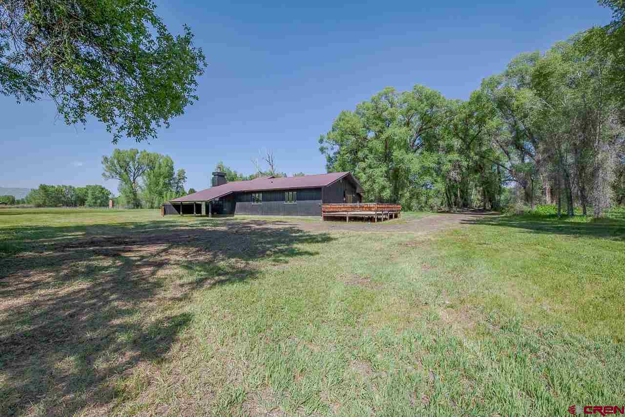 171 Arapahoe Road Gunnison, CO 81230 - Photo 30 of 34 Level grounds, mature trees, grassy lawns.