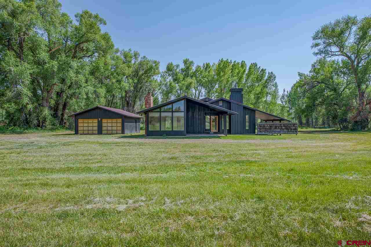 171 Arapahoe Road Gunnison, CO 81230 - Photo 3 of 34 Facing North, ranch home, two detached garages, shed, irrigated pasture, borders Clark Stream.