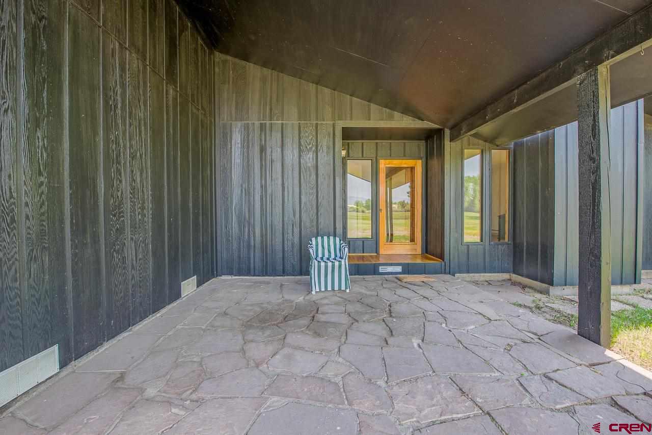 171 Arapahoe Road Gunnison, CO 81230 - Photo 6 of 34 Covered front porch with views to the North overlooking pasture with Ohio Creek mountain views.