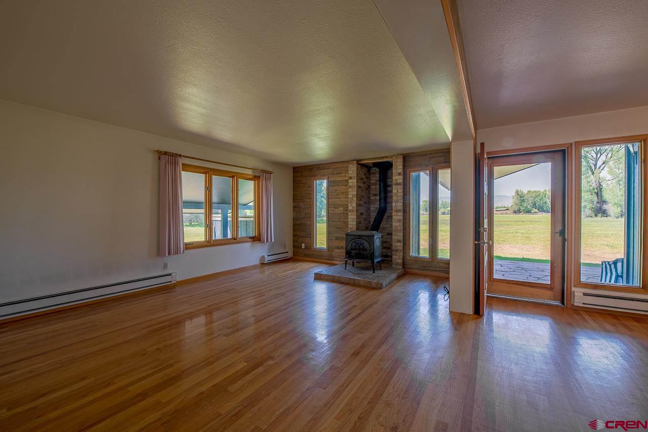 171 Arapahoe Road Gunnison, CO 81230 - Photo 7 of 34 Sunny, bright and open concept with views, wood burning stove.