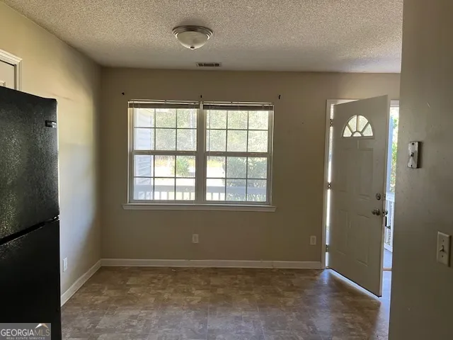 an empty room with windows and closet