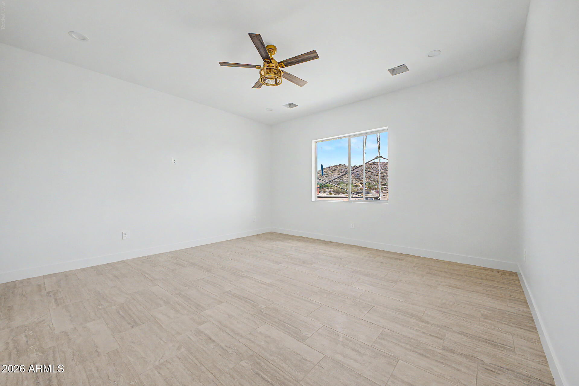 18815 West Arlington Road Buckeye, AZ 85326 - Photo 21 of 56 an empty room with window and ceiling fan