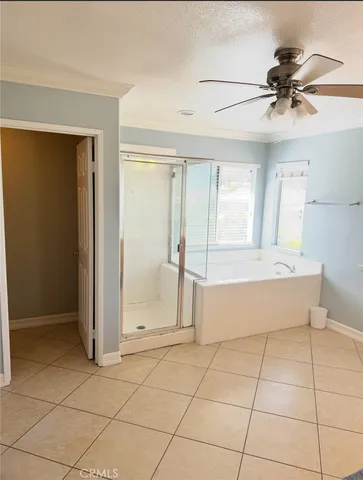 a spacious bathroom with a tub and a shower