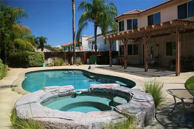 a view of a house with swimming pool and sitting area
