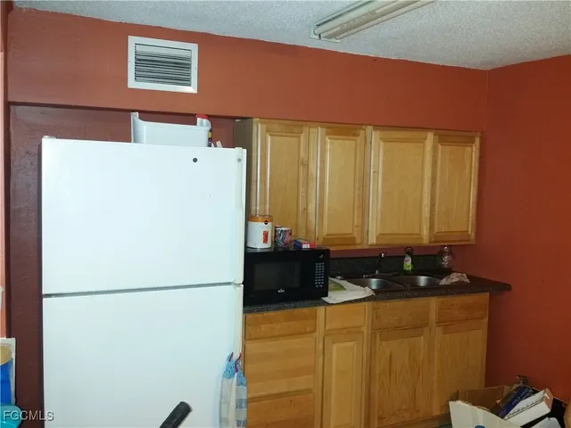 a white refrigerator freezer sitting in a kitchen