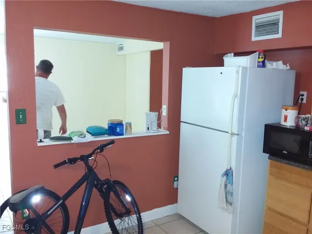 a white refrigerator freezer sitting in a kitchen