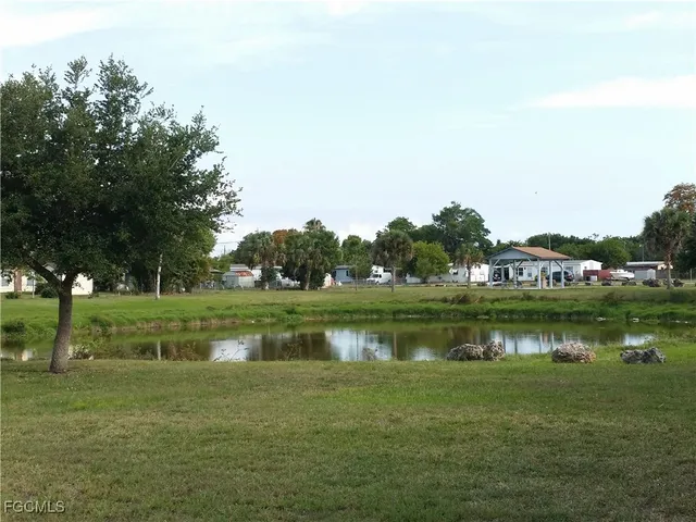 a view of a swimming pool and a lawn chairs under an umbrella