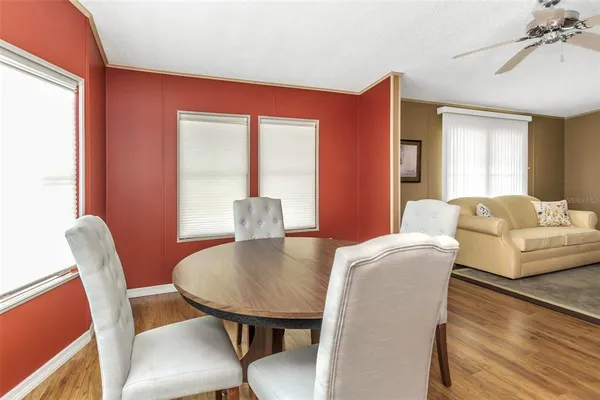 a bedroom with a bed a mirror and a chandelier