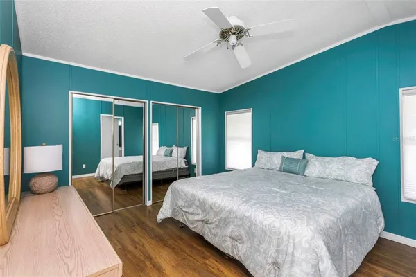 a bedroom with a bed and a mirror