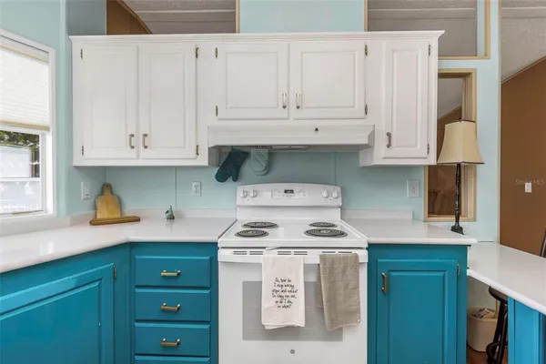 a kitchen with granite countertop wooden cabinets a sink and a window