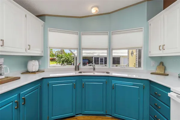 a kitchen with stainless steel appliances white cabinets and a refrigerator