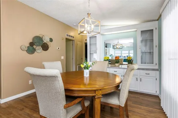 a dining room with furniture and wooden floor