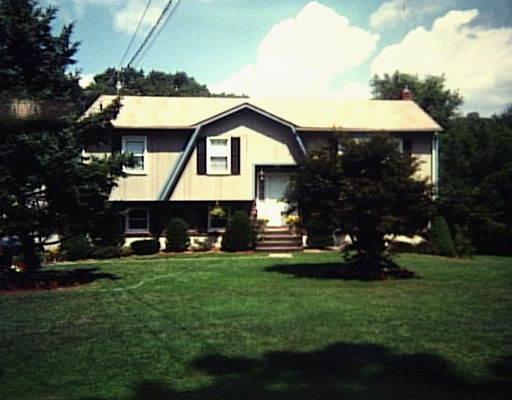 11 Shelley Road Bethel, CT 06801 - Photo 1 of 1 a front view of a house with a garden and trees