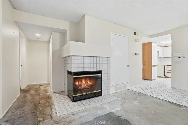a view of an empty room with a fireplace