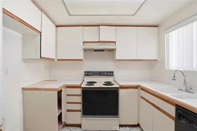 a kitchen with stainless steel appliances a stove a sink and a microwave