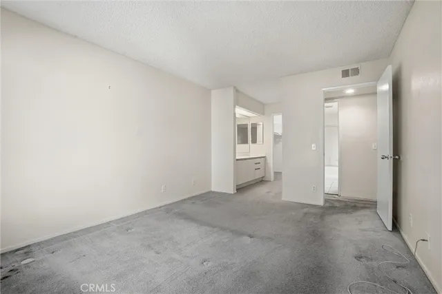 an empty room with windows and bathroom