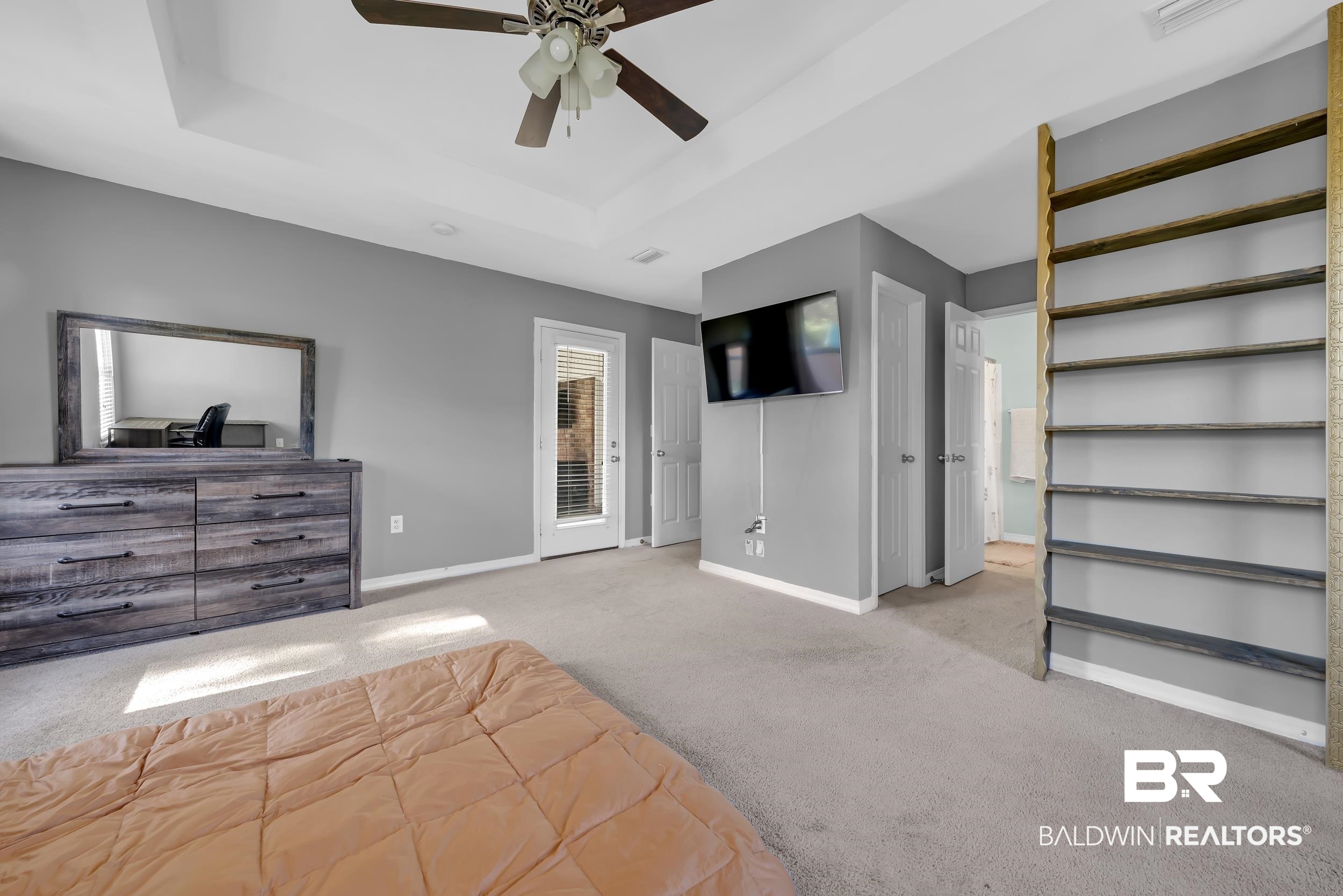 31527 Heidelbrook Loop Daphne, AL 36527 - Photo 12 of 22 Unfurnished bedroom featuring a raised ceiling, carpet floors, a ceiling fan, and access to exterior