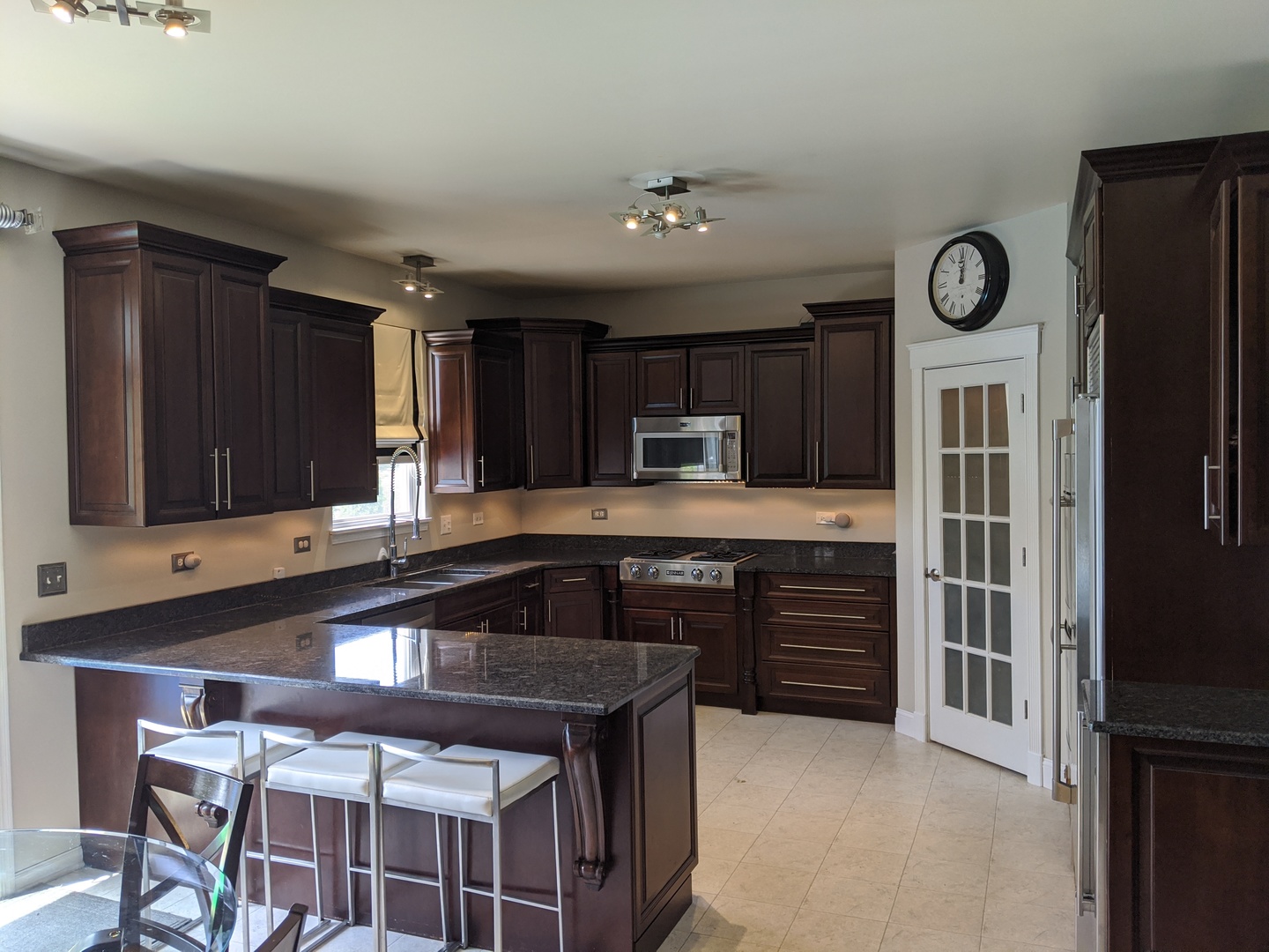 3545 High Ridge Road Carpentersville, IL 60110 - Photo 14 of 35 a kitchen with kitchen island granite countertop a stove refrigerator and cabinets
