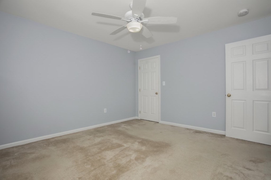 3 Bancroft Avenue, Unit 3 Reading, MA 01867 - Photo 12 of 19 an empty room with a chandelier fan and windows