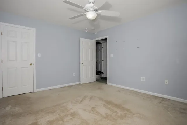 a view of an empty room with a ceiling fan