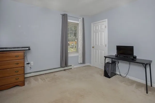 a view of work space with furniture and windows