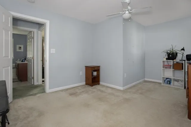 an empty room with closet and a chandelier fan