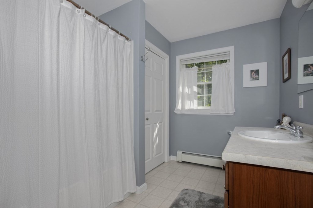 3 Bancroft Avenue, Unit 3 Reading, MA 01867 - Photo 17 of 19 a bathroom with a sink and a mirror
