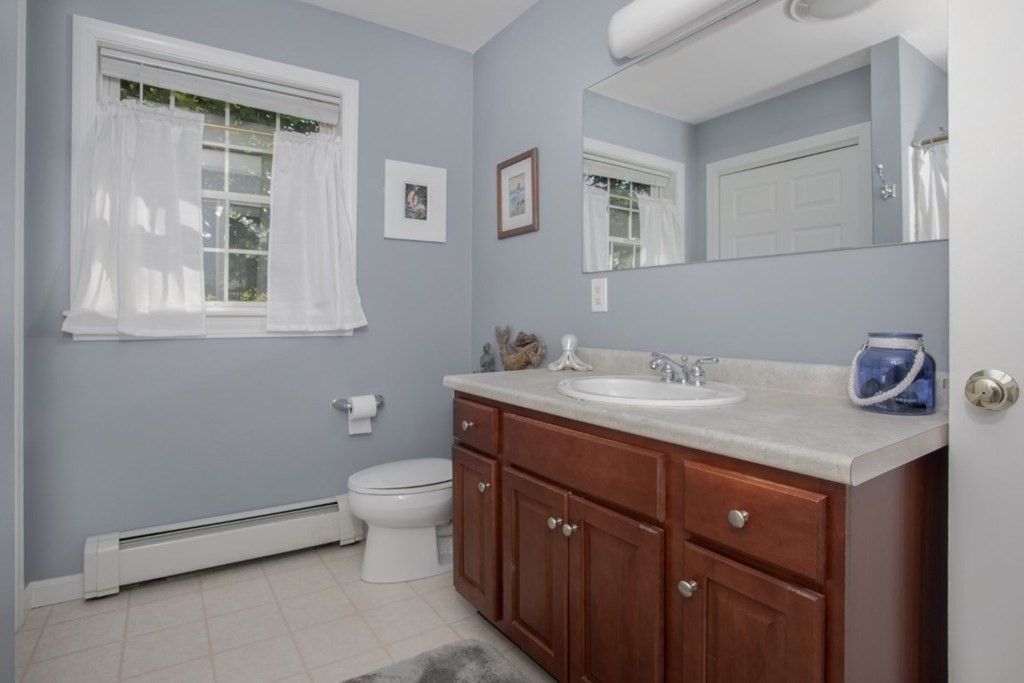 3 Bancroft Avenue, Unit 3 Reading, MA 01867 - Photo 18 of 19 a bathroom with a sink a toilet and a window