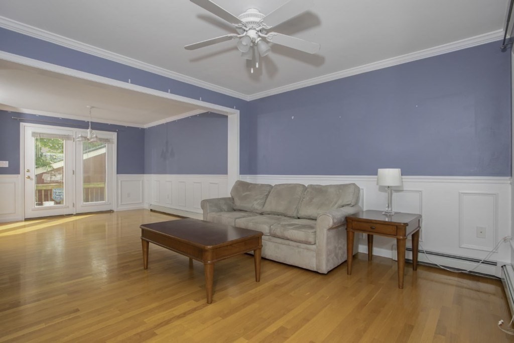 3 Bancroft Avenue, Unit 3 Reading, MA 01867 - Photo 2 of 19 a living room with furniture and a wooden floor