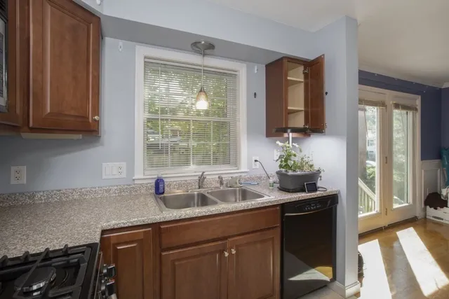 a kitchen with granite countertop a sink and a window