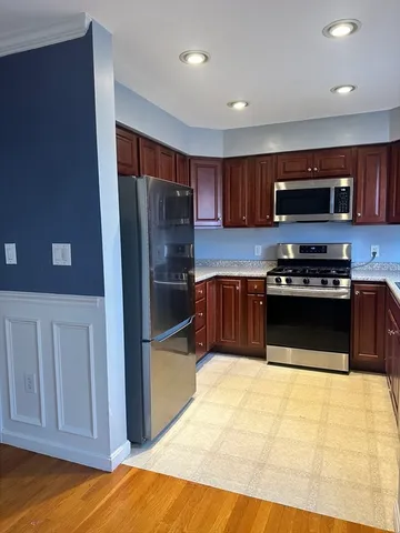 a kitchen with stainless steel appliances a stove a microwave and a refrigerator