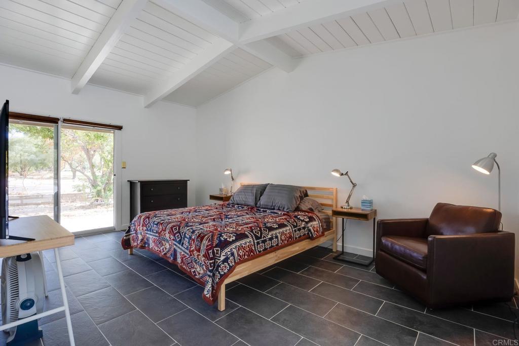 255 Montezuma Road Borrego Springs, CA 92004 - Photo 14 of 26 a bedroom with a bed and a couch