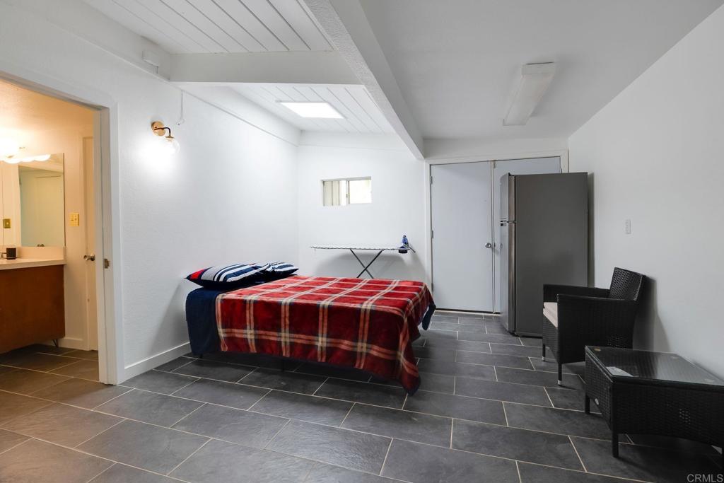 255 Montezuma Road Borrego Springs, CA 92004 - Photo 20 of 26 a spacious bedroom with a bed and a table in it