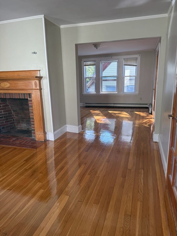 38 Everton Street, Unit 2 Boston, MA 02121 - Photo 2 of 9 wooden floor in an empty room with a fireplace