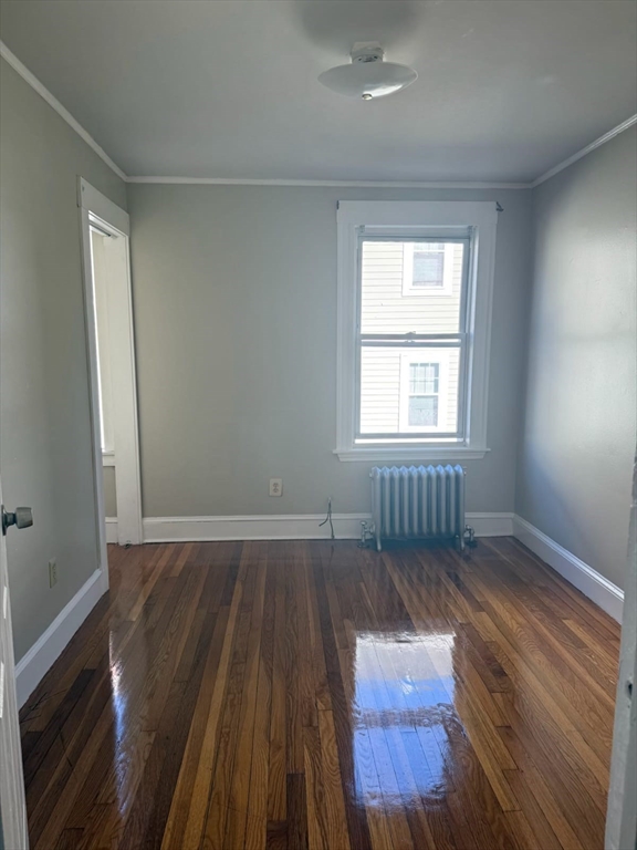 38 Everton Street, Unit 2 Boston, MA 02121 - Photo 4 of 9 an empty room with wooden floor and windows