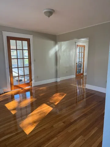 wooden floor with view of empty room