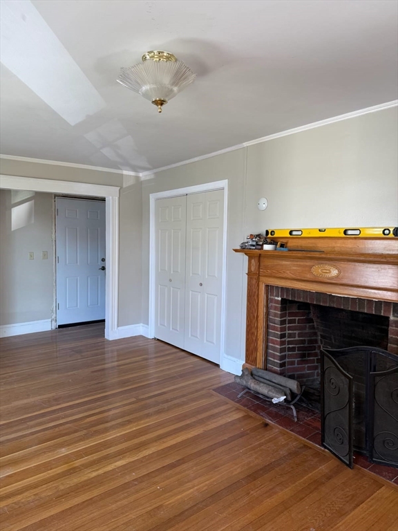 38 Everton Street, Unit 2 Boston, MA 02121 - Photo 8 of 9 a view of an empty room with wooden floor fireplace and a window