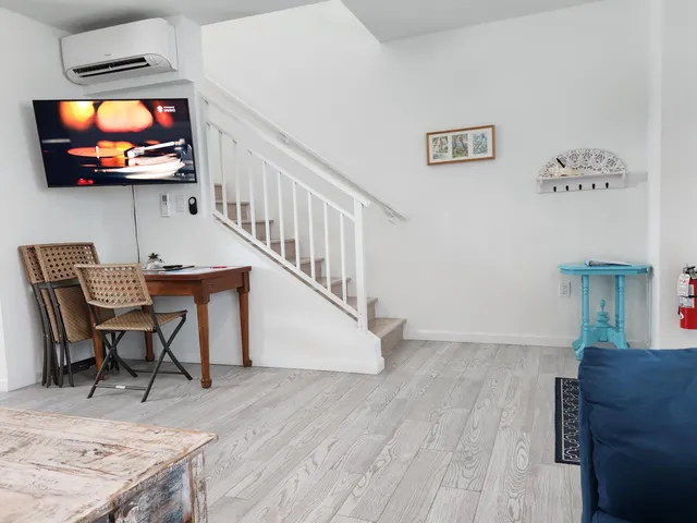 a view of a livingroom with furniture and a flat screen tv