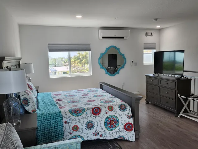 a bedroom with a bed and a flat screen television