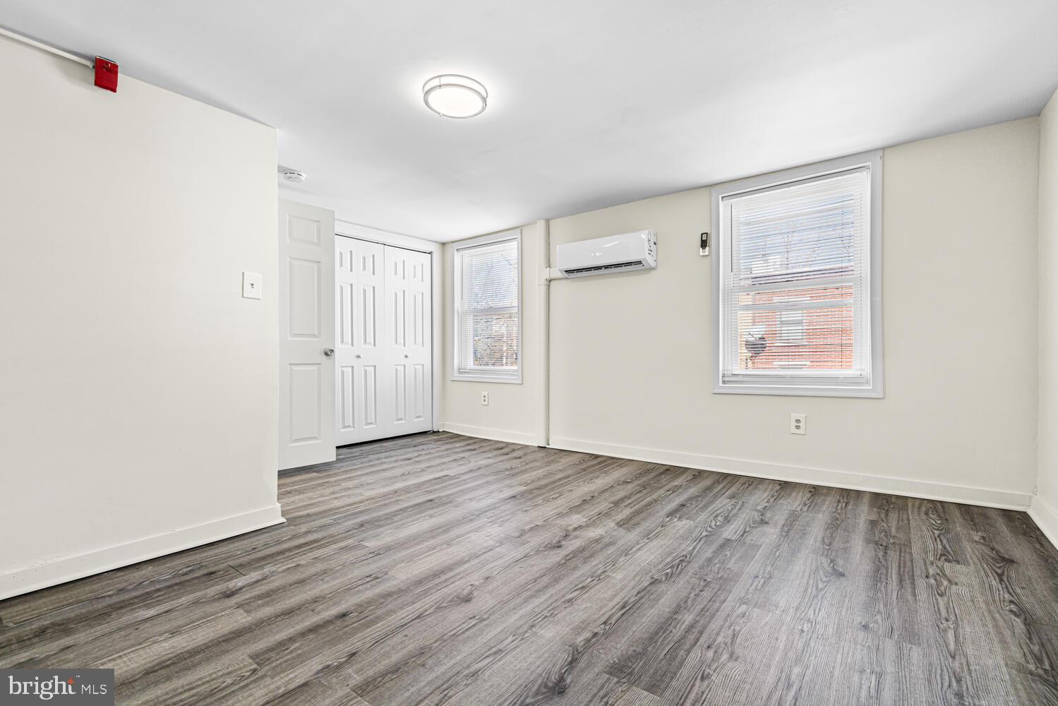 178 Master Street Philadelphia, PA 19122 - Photo 16 of 19 an empty room with wooden floor and windows