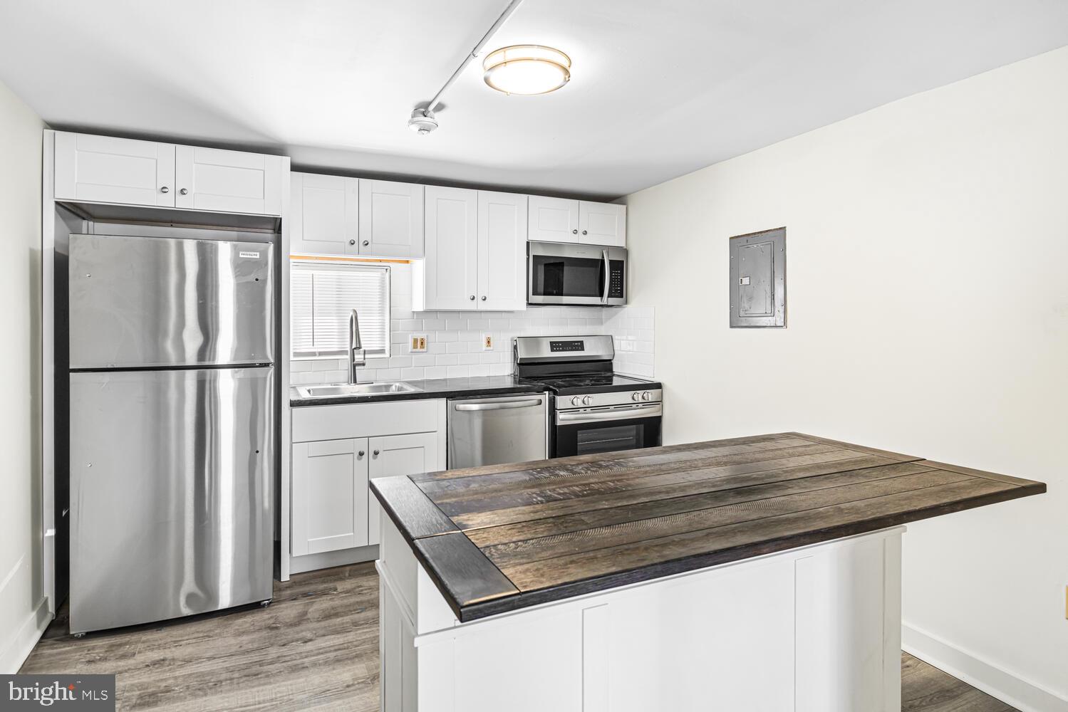 178 Master Street Philadelphia, PA 19122 - Photo 7 of 19 a kitchen with kitchen island a sink appliances and cabinets