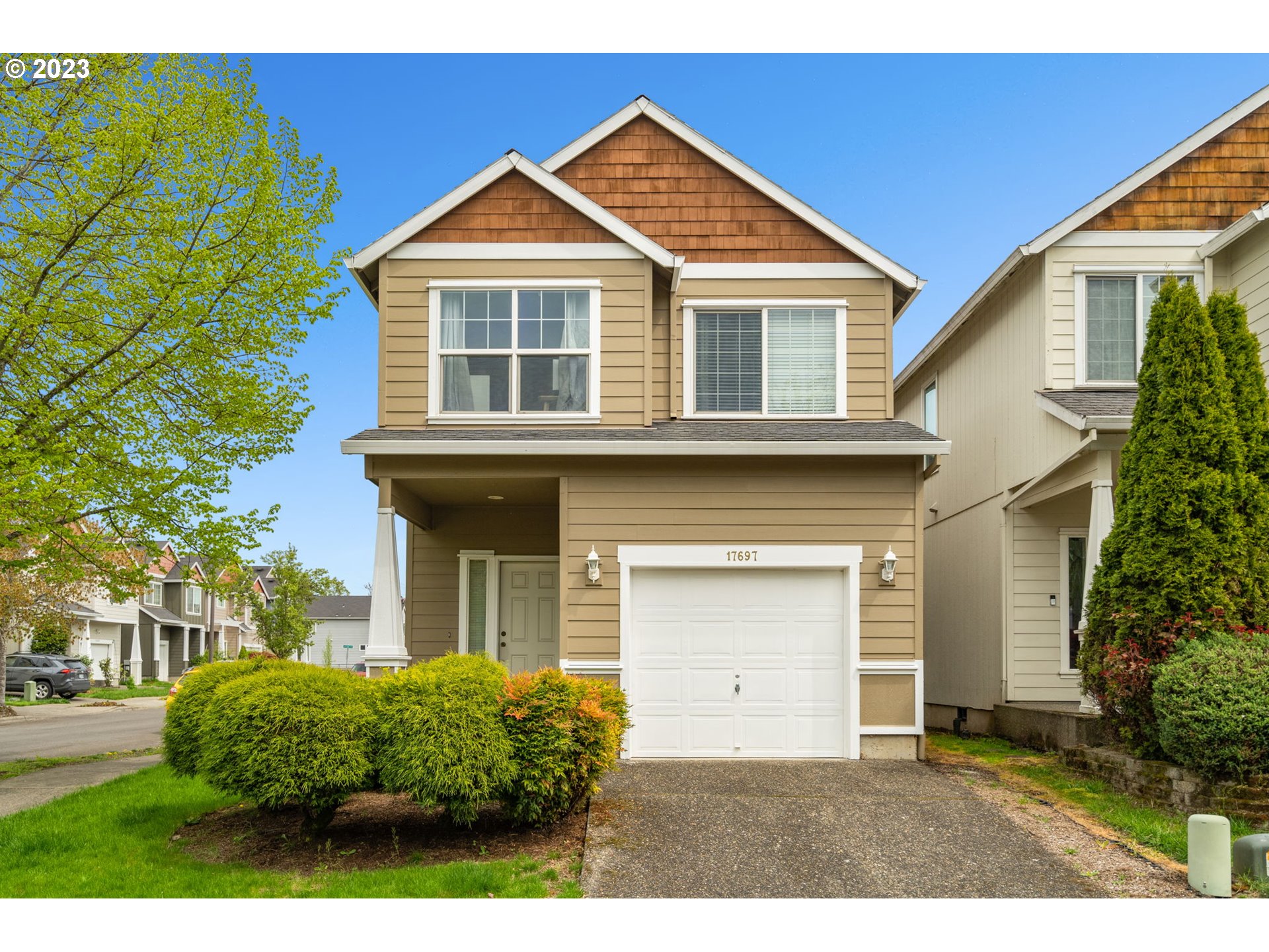 a front view of a house with a garden and plants