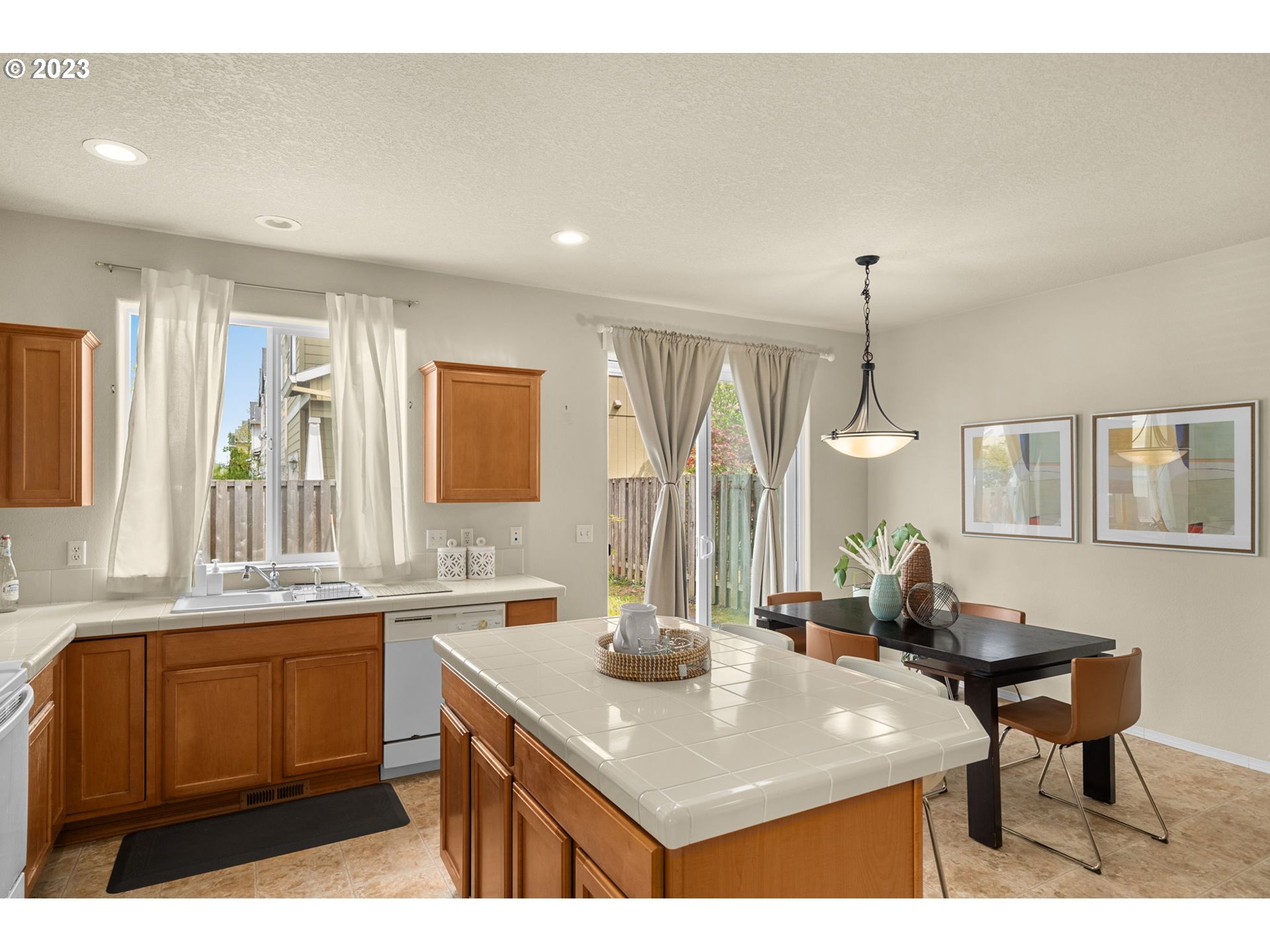 17697 Southwest September Lane Beaverton, OR 97003 - Photo 11 of 24 a kitchen with a sink a counter space and a view of living room