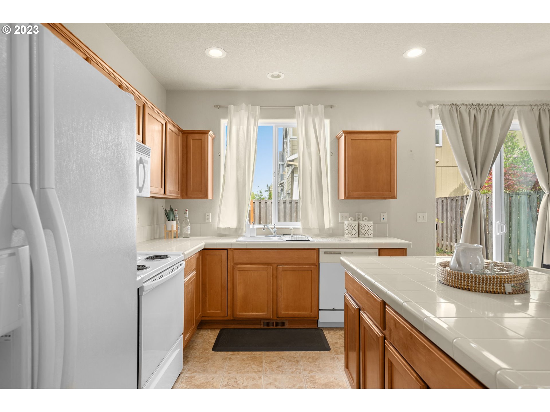 17697 Southwest September Lane Beaverton, OR 97003 - Photo 10 of 24 a kitchen with stainless steel appliances granite countertop a sink stove and cabinets
