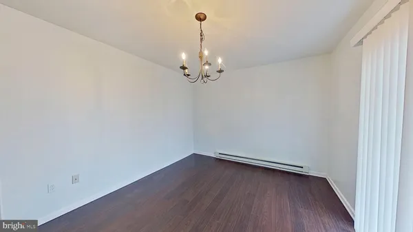 a view of a room with wooden floor and ceiling fan