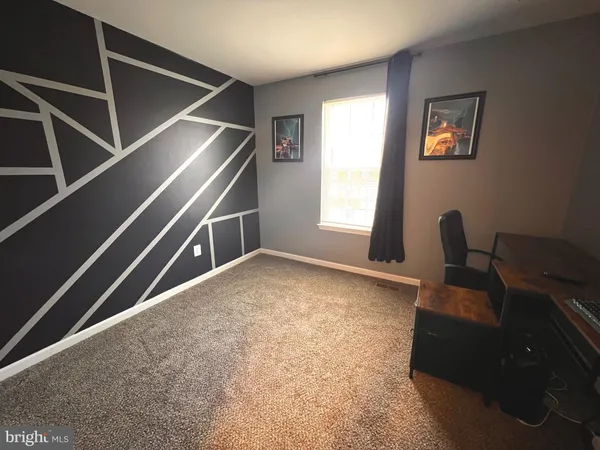 a view of room with window and flat screen tv